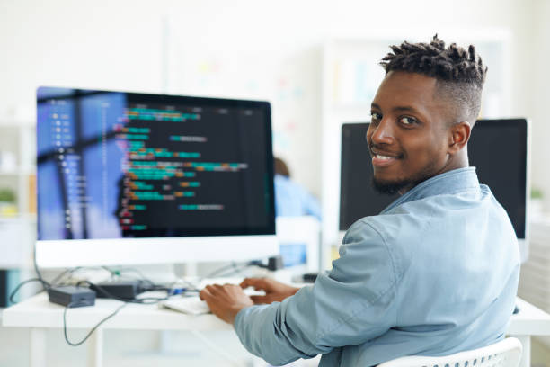 A Web Designer in Kenya working on a laptop, creating a visually appealing website that represents the contents, mood, and theme of a professional web design article.
